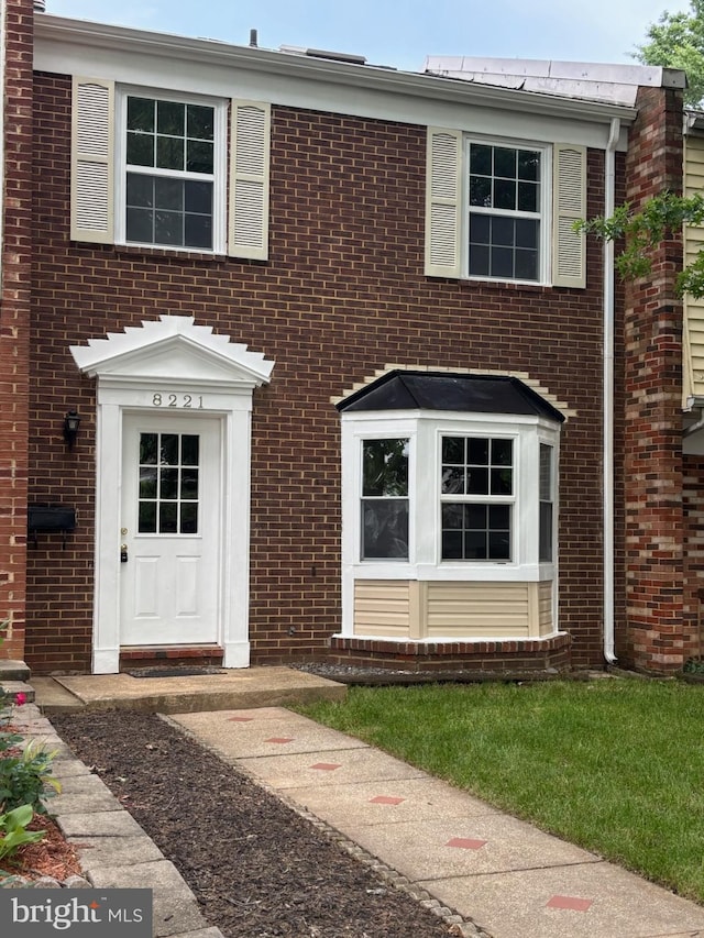 view of front of home featuring brick siding