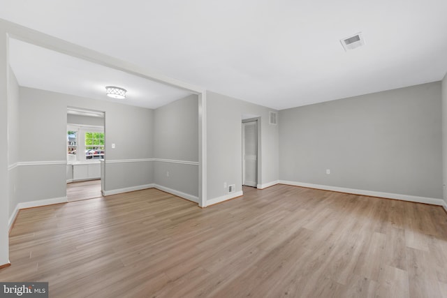 empty room with light wood-style floors and baseboards