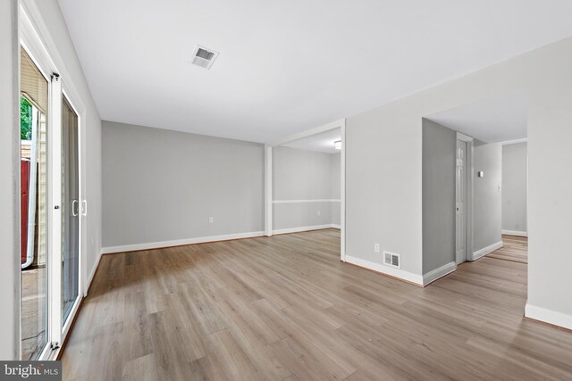 unfurnished room featuring light wood-type flooring and baseboards