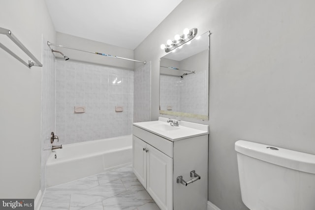full bath with toilet, shower / bath combination, vanity, and marble look tiles