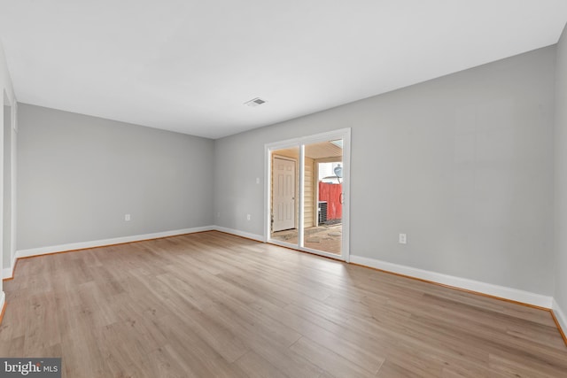 empty room with light wood-style floors and baseboards