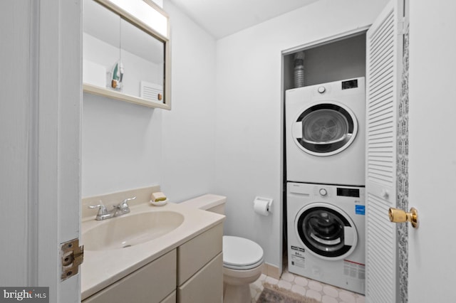 922 Montgomery Ave Unit E2, Bryn Mawr, PA 19010 - bathroom featuring stacked washing machine and dryer, toilet, and vanity