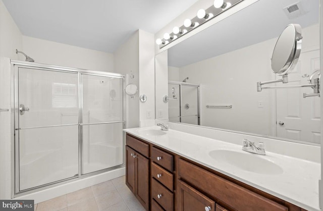36518 Harmon Bay Blvd Unit 27, Rehoboth Beach, DE 19971 - full bath featuring tile patterned flooring, an enclosed shower, and double vanity