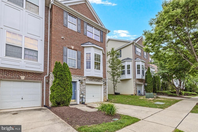 3334 Castle Ridge Cir Unit 8, Silver Spring, MD 20904 - townhome / multi-family property featuring concrete driveway, an attached garage, stone siding, and brick siding