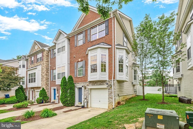 3334 Castle Ridge Cir Unit 8, Silver Spring, MD 20904 - multi unit property featuring stone siding, concrete driveway, a front yard, an attached garage, and a residential view