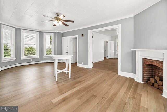 201 E Main St, Fairfield, PA 17320 - unfurnished living room featuring ceiling fan, wood finished floors, a brick fireplace, and baseboards