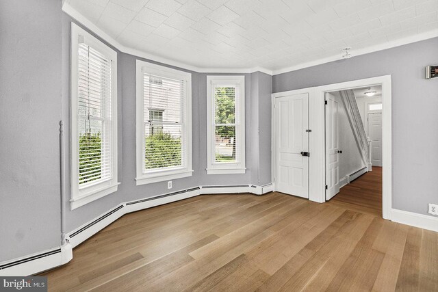 201 E Main St, Fairfield, PA 17320 - unfurnished bedroom featuring a baseboard radiator, wood finished floors, crown molding, and baseboards