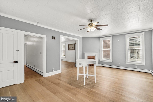 201 E Main St, Fairfield, PA 17320 - empty room with a baseboard heating unit, a ceiling fan, and light wood finished floors