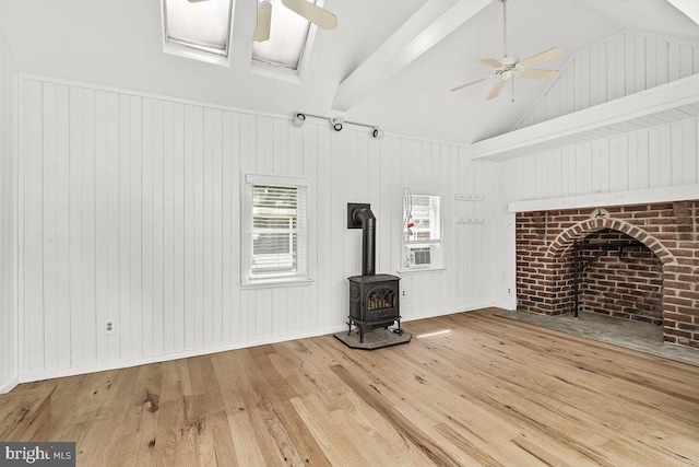 201 E Main St, Fairfield, PA 17320 - unfurnished living room with a ceiling fan, vaulted ceiling, hardwood / wood-style flooring, a wood stove, and wood walls