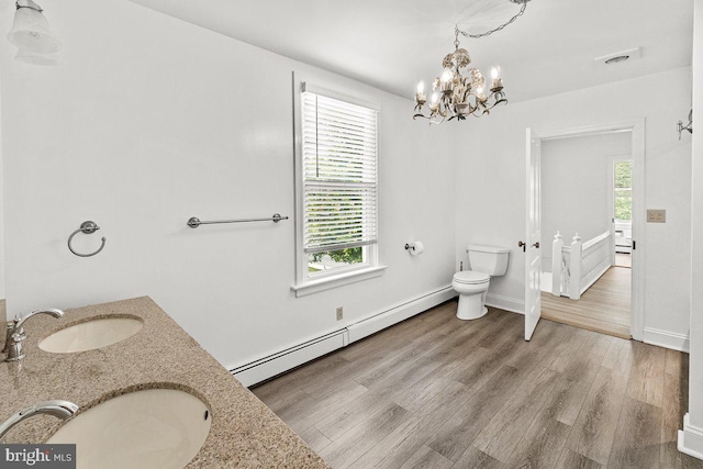 201 E Main St, Fairfield, PA 17320 - bathroom featuring a baseboard radiator, a chandelier, toilet, wood finished floors, and double vanity