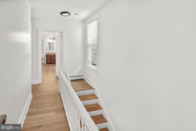 201 E Main St, Fairfield, PA 17320 - corridor featuring light wood-style flooring, a chandelier, baseboards, a baseboard heating unit, and stairs