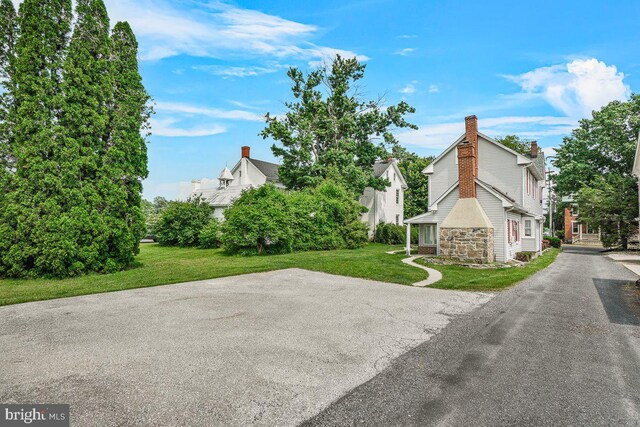 201 E Main St, Fairfield, PA 17320 - view of side of home with a yard, stone siding, and a chimney