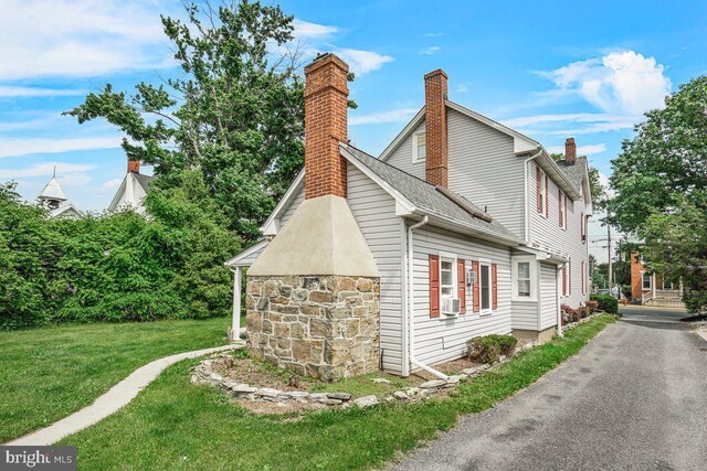 201 E Main St, Fairfield, PA 17320 - view of side of property featuring a chimney, a lawn, cooling unit, and roof with shingles