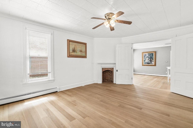 201 E Main St, Fairfield, PA 17320 - unfurnished living room featuring a ceiling fan, a fireplace, a baseboard heating unit, light wood finished floors, and crown molding