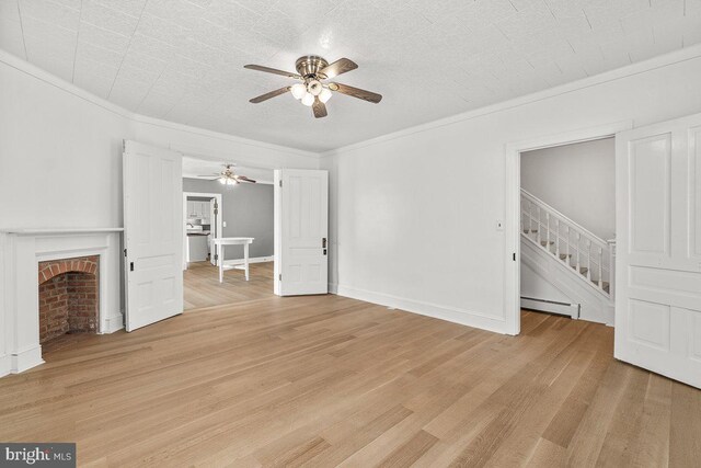 201 E Main St, Fairfield, PA 17320 - unfurnished living room featuring a baseboard radiator, a ceiling fan, stairway, light wood-style floors, and ornamental molding