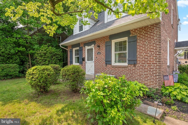 1505 Wynnewood Rd, Ardmore, PA 19003 - cape cod house featuring brick siding, a front lawn, and a shingled roof