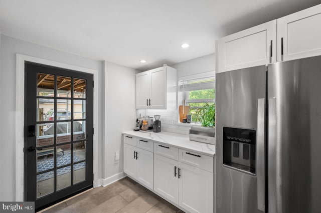 1505 Wynnewood Rd, Ardmore, PA 19003 - kitchen with stainless steel fridge with ice dispenser, white cabinets, light stone countertops, tasteful backsplash, and recessed lighting