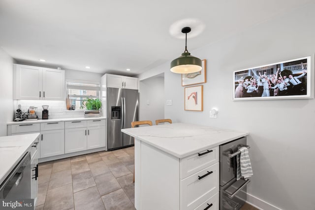 1505 Wynnewood Rd, Ardmore, PA 19003 - kitchen with appliances with stainless steel finishes, white cabinetry, backsplash, pendant lighting, and light stone countertops