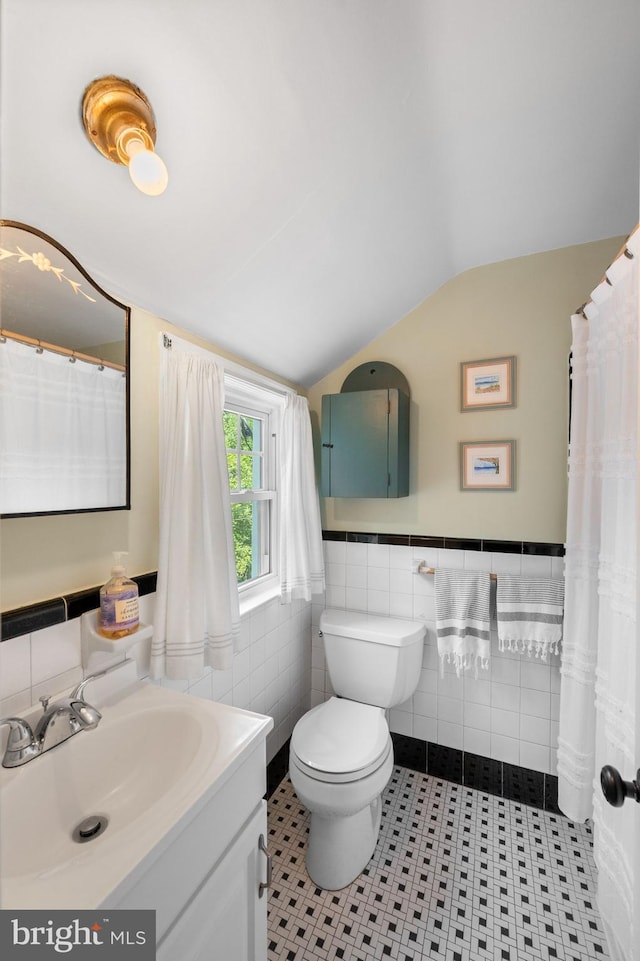 1505 Wynnewood Rd, Ardmore, PA 19003 - bathroom featuring tile walls, lofted ceiling, vanity, wainscoting, and tile patterned flooring