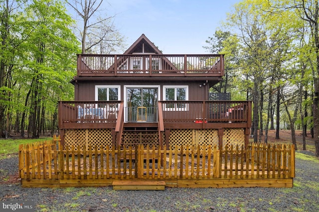 back of house with a deck and a balcony