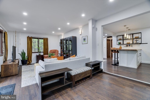 living room featuring dark wood finished floors, recessed lighting, and baseboards