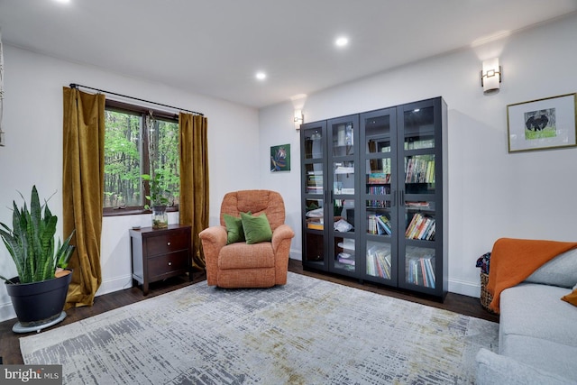 living area with wood finished floors, recessed lighting, and baseboards