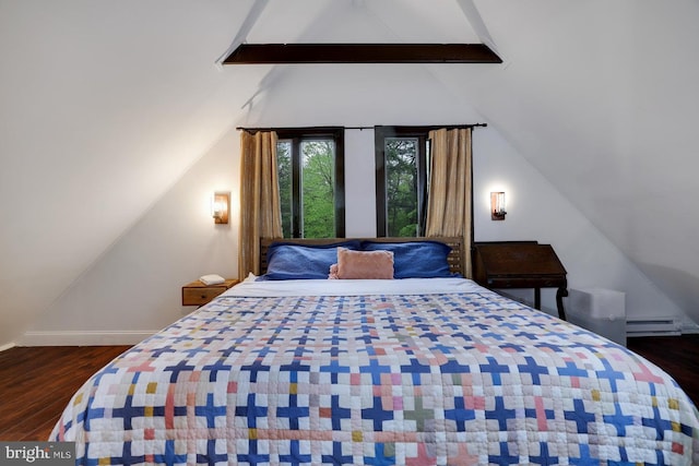 bedroom featuring wood finished floors, baseboard heating, and baseboards