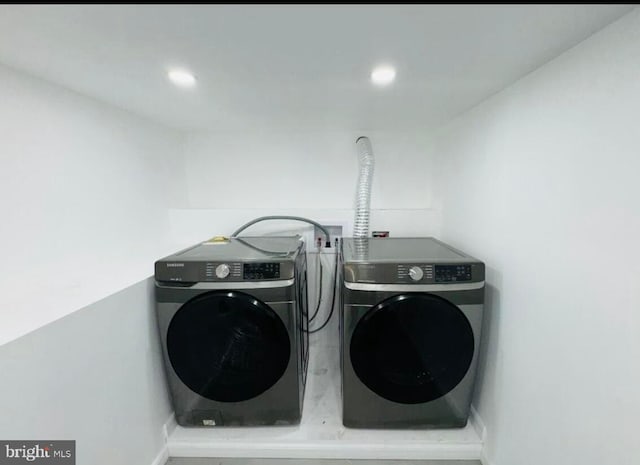 laundry area featuring separate washer and dryer, baseboards, and recessed lighting