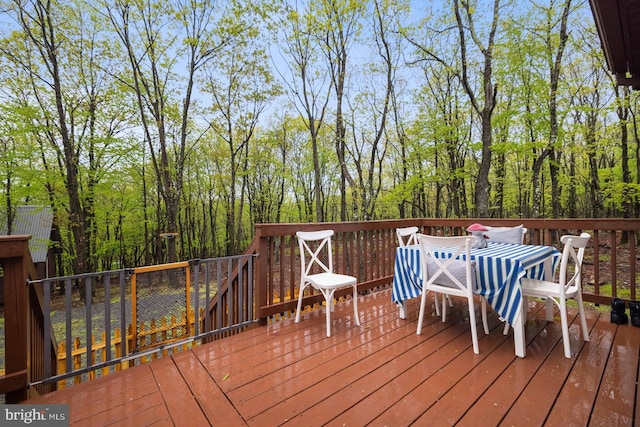 wooden deck with outdoor dining area