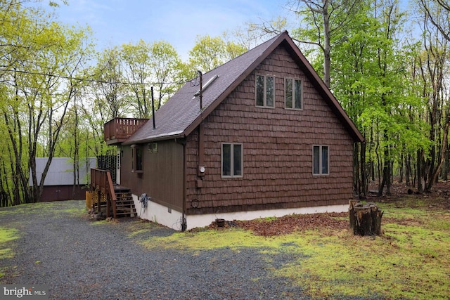 view of home's exterior with a shingled roof