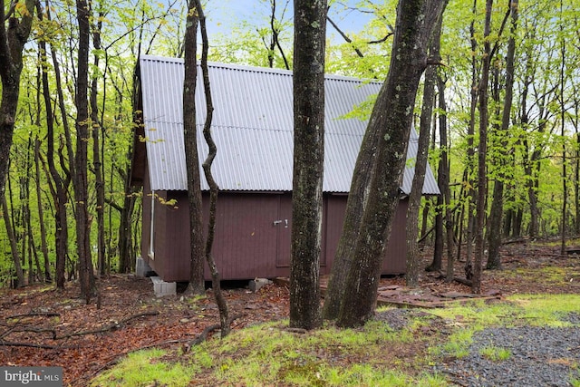view of side of home featuring metal roof