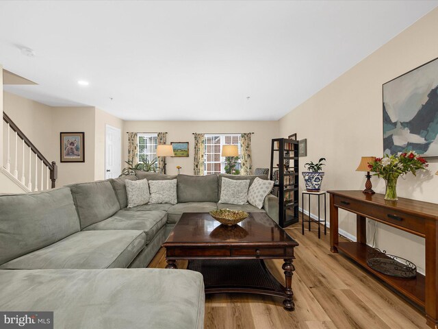 1413 Peregrine Path, Arnold, MD 21012 - living area featuring light wood-style floors, stairway, and baseboards