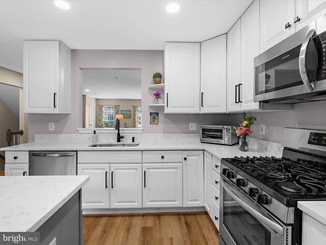 1413 Peregrine Path, Arnold, MD 21012 - kitchen featuring appliances with stainless steel finishes, a sink, recessed lighting, light wood-type flooring, and white cabinets