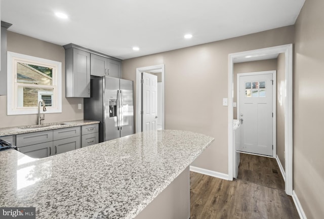 113 N Broad St, Penns Grove, NJ 08069 - kitchen with stainless steel fridge with ice dispenser, gray cabinetry, a sink, dark wood finished floors, and baseboards