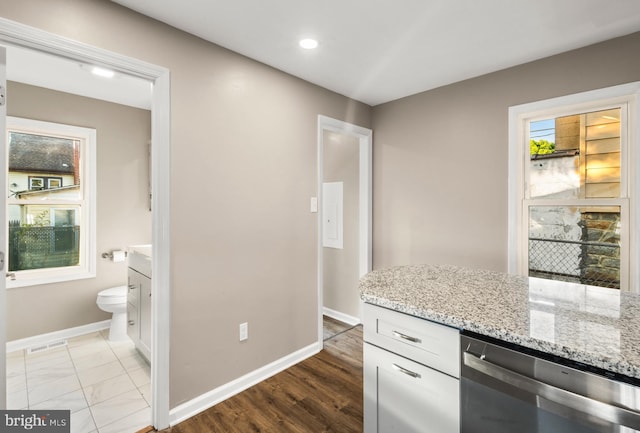 113 N Broad St, Penns Grove, NJ 08069 - kitchen featuring dishwasher, baseboards, light stone counters, white cabinetry, and recessed lighting