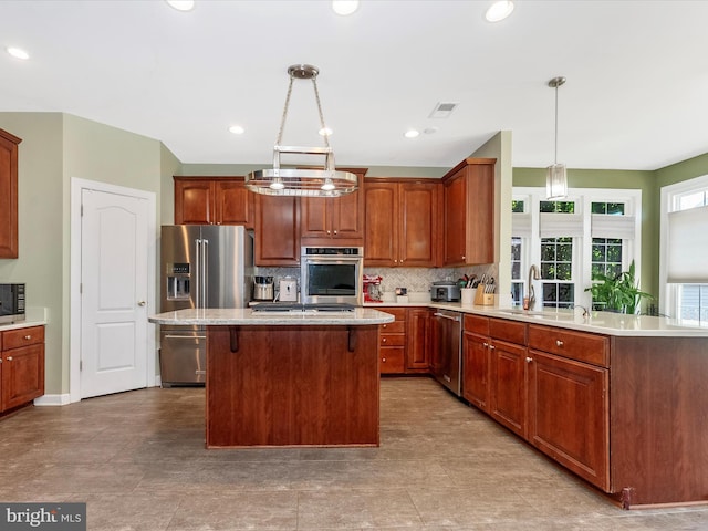 106 Bedrock Dr, Walkersville, MD 21793 - kitchen with appliances with stainless steel finishes, a sink, decorative backsplash, a kitchen island, and pendant lighting
