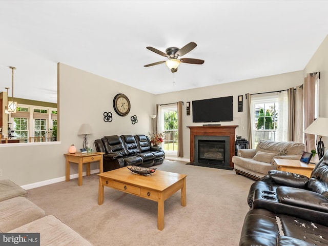 106 Bedrock Dr, Walkersville, MD 21793 - living area with light carpet, a ceiling fan, a fireplace with flush hearth, and baseboards
