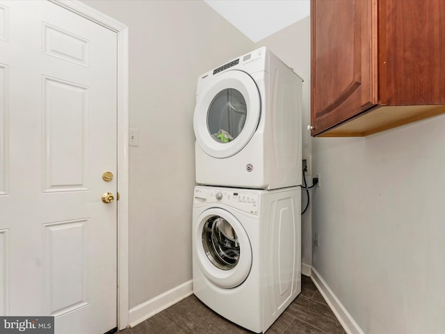 106 Bedrock Dr, Walkersville, MD 21793 - washroom with stacked washing machine and dryer, cabinet space, baseboards, and dark wood-style floors