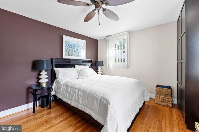 806 S Beechfield Ave, Baltimore, MD 21229 - bedroom with baseboards, light wood-style flooring, and ceiling fan