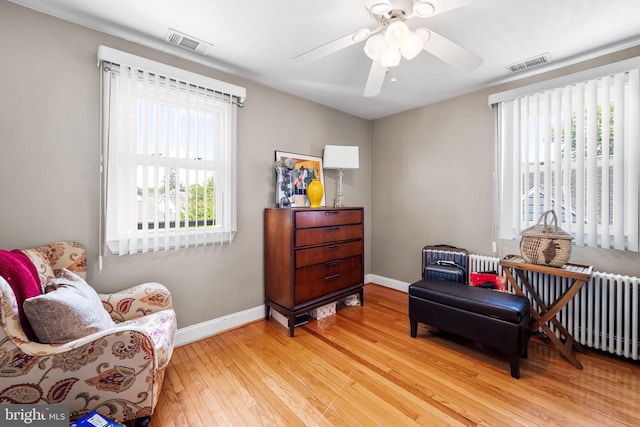 806 S Beechfield Ave, Baltimore, MD 21229 - sitting room featuring wood-type flooring, baseboards, a ceiling fan, and radiator
