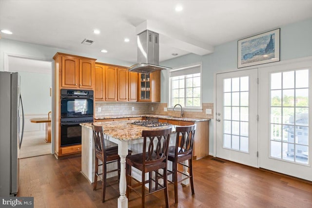 313 Indianhead Ct, Woodstock, VA 22664 - kitchen featuring stainless steel appliances, island exhaust hood, a sink, dark wood finished floors, and light stone countertops