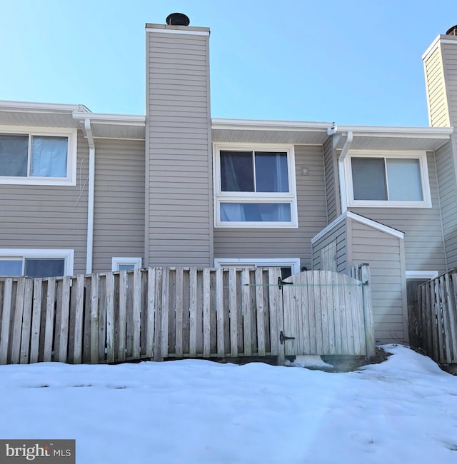290 Hilltop Ln, Annapolis, MD 21403 - snow covered house with a chimney and fence