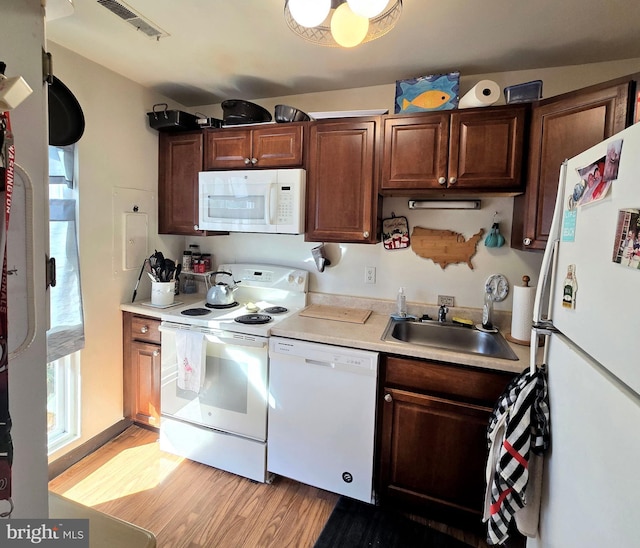 290 Hilltop Ln, Annapolis, MD 21403 - kitchen with white appliances, a sink, light wood-style flooring, and light countertops
