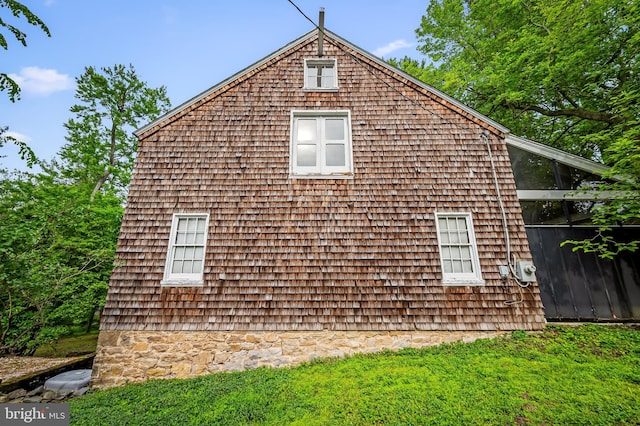 view of property exterior featuring a lawn