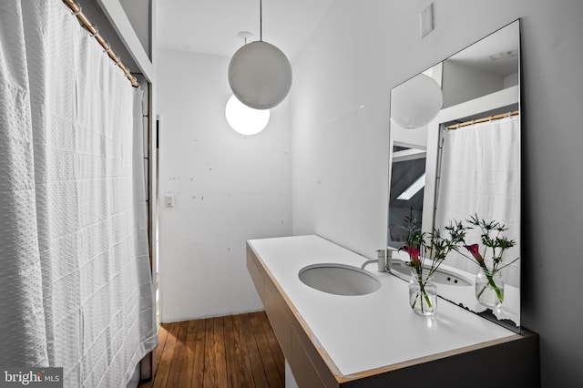 full bathroom with hardwood / wood-style floors and vanity