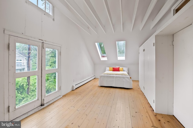 bedroom featuring a baseboard radiator, a skylight, and wood-type flooring