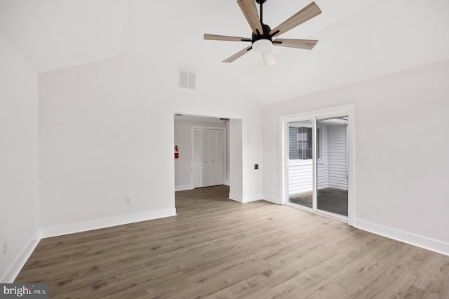 unfurnished room featuring wood finished floors, ceiling fan, baseboards, and high vaulted ceiling