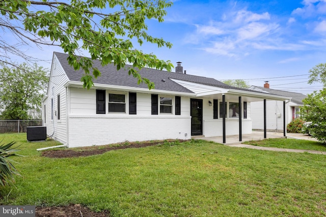 ranch-style home featuring brick siding, central AC, a chimney, roof with shingles, and a patio area