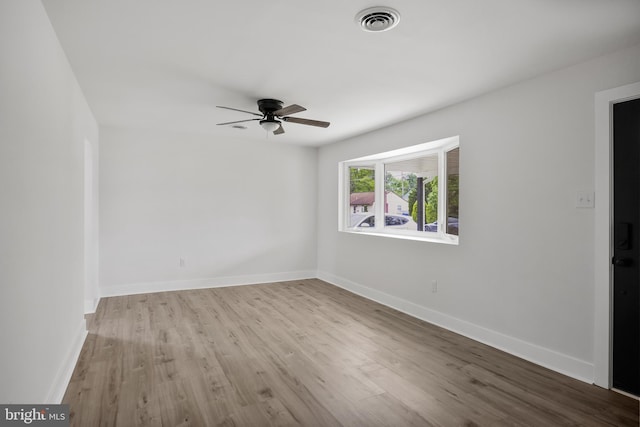 unfurnished room with wood finished floors, ceiling fan, and baseboards