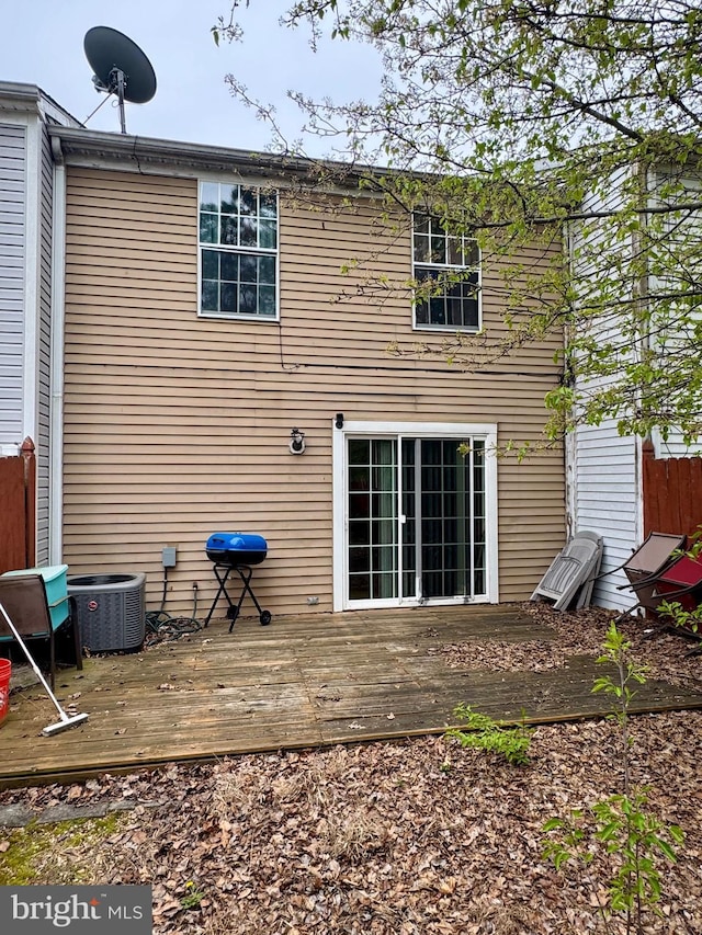 back of house with a deck and central air condition unit